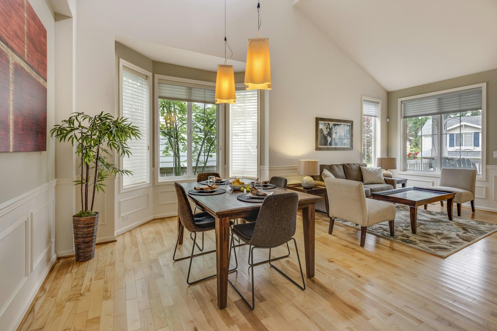 Dining and living area with light oak flooring