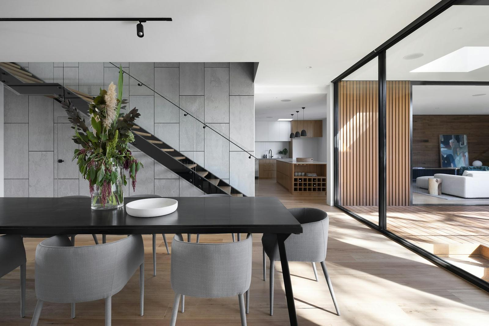 Open living and dining space with light wood-look plank flooring